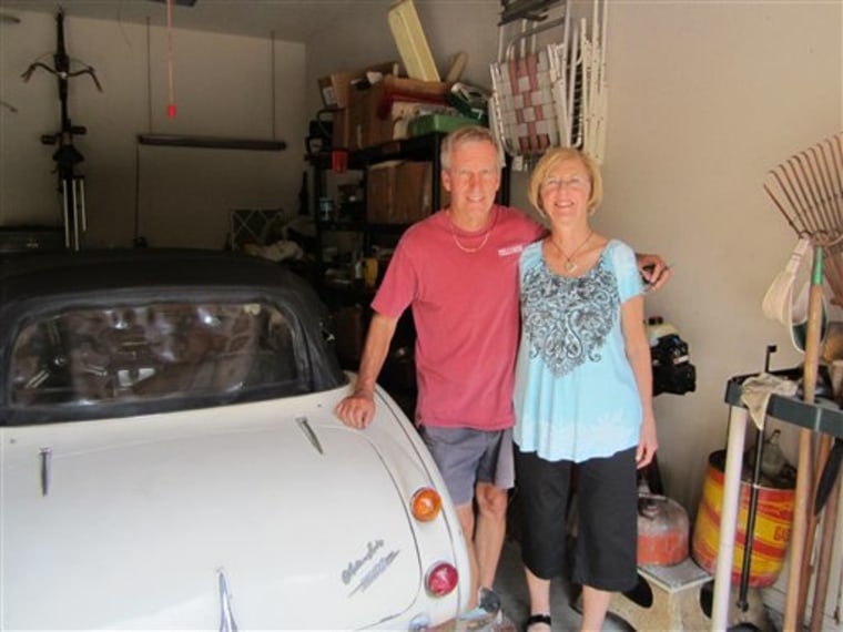 Robert Russell and his wife with the car back in their Texas garage.